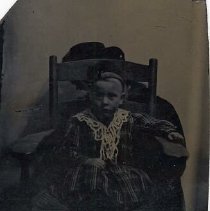 Unidentified child in plaid dress, ca.1865.