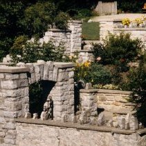 ph 18241_16 [View from footbridge?] of archway, wall, flowers and bench, Ju