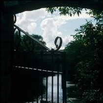 ph 18244_7 View through gate to river and clouds, 7 Sept. 1995.