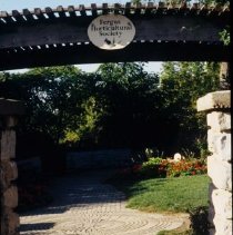 ph 18246_11 View through entranceway under bower with sign, 1998.
