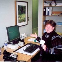 ph 20582 Jill McGeorge at desk