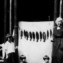 Woman and children with a stringer of fish, photograph, 1920.