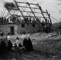Men and women at barn raising, near Harriston, Minto Township, 1901.