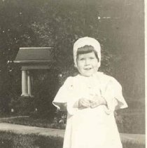 Toddler wearing a cotton dress, photograph, ca. 1915.