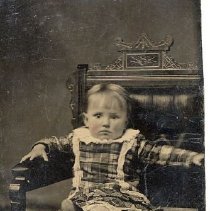 Unidentified child wearing plaid dress, ca.1865.