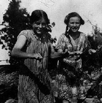 Edith and Norma Short of Mount Forest, holding on to a barbed wire fence, photograph, ca. 1925.