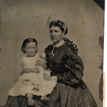 Unidentified woman, and girl holding a doll, ca.1865.