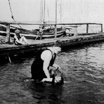 Woman teaching a child to swim, photograph, ca. 1915.