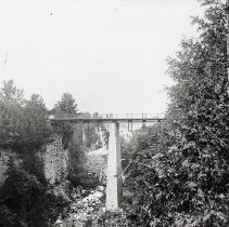 Two people standing on Irvine Bridge, Elora, ca. 1910