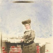 ph 16085: Hand coloured portrait of Bessie Grange, on roof, when they lived
