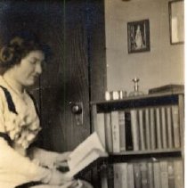 ph 16091: Maynard [Grange], seated, looking at a book.