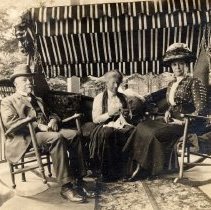 ph 16105: Two women and man, seated beneath awning [Kingsmill / Cruickston