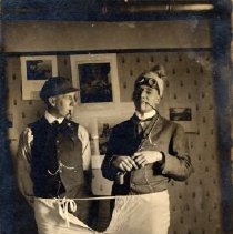 ph 16117: Three men [Grange?]. Two with hats and pipes; third man, on floor