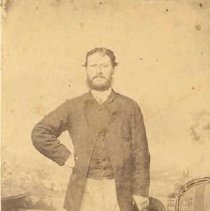 ph 16078: Man standing next to chair, Guelph.