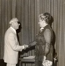 PH 23721 Eleanore Smith receiving handshake upon retirement. ca. 1977