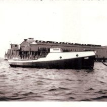 Boat tied up in front of sardine factory