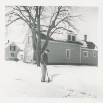 Bob Grasse with snow shovel in front of Al Parker's house.