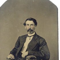 Middle aged man with dark hair a bushy mustache
