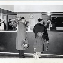 A family standing at the front desk of the Midalnd Hospital