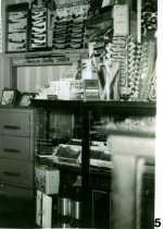 Inside drugstore near the cigars and pipes