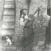 Man with guitar and dog