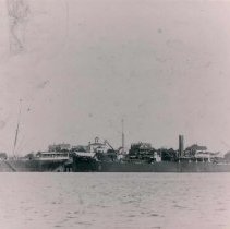 Two steam ships docked bow to stern