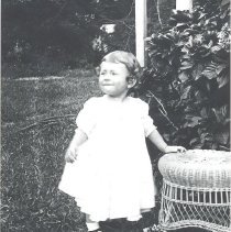 Mary Helen Hall in yard next to table