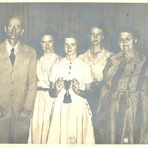 Young girl with trophy and her family