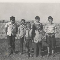 Boys standing near construction of Seaside Inn