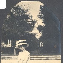 Photo of lady sitting by dirt road