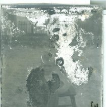Unknown boy next to stool