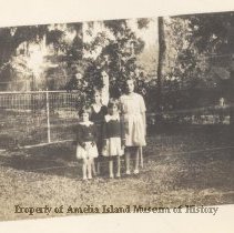 A Group in Front of a Flower Bush