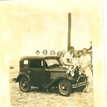 unidentified group of people next to a car
