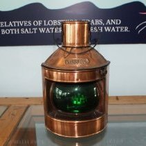 Brass ships lantern with green glass bulb.