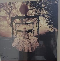 Poster with Girl on a Bed with a balloon in the trees.