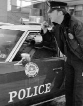 Aurora Police Department Officer in front of police cruiser