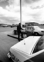 Police officer at gas pumps