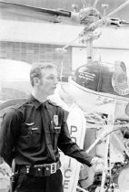 Aurora Police Officer in front of helicopter