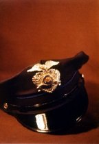 Black, visored police cap.