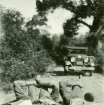 Men Laying Down in Front of Car