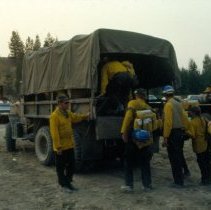 fire fighters getting into a covered truck