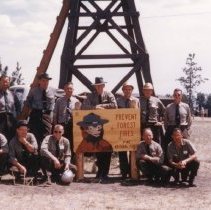 Rangers beside Smokey Prevent Forest Fires Sign and Lookout