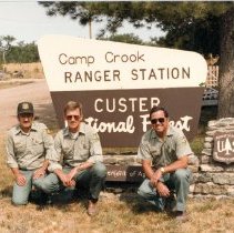 Rangers by Camp Crook Ranger Station Sign