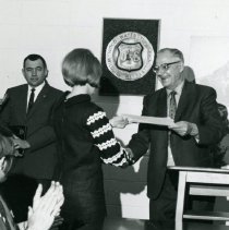 Judy Baker Receiving Award from Supervisor Ahlskog