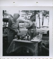 Women by outside food table outside in summertime