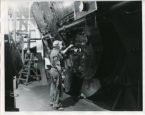 Standard Oil Co. employee standing at machine (original)