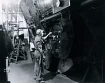 Standard Oil Co. employee at machine (restored)