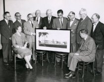 Gavit board members holding a framed picture of the school