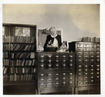 A girl standing behind a small card catalog in the Children's Room at the Bridgeport Public Library