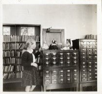 A girl looking at dolls on a card catalog at the Bridgeport Public Library